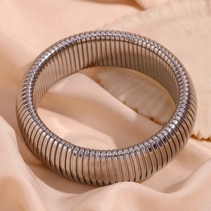 Detail view of 20mm wide silver snake chain bracelet on pink silk with sea shells