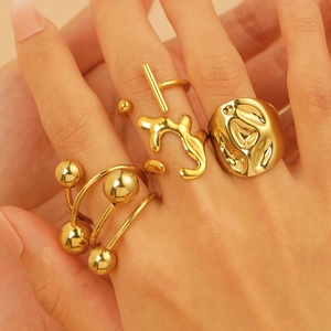 Detailed view of 18K gold plated stainless steel rings set in lava and geometric designs