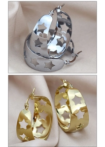 Detail view showing hollow star patterns on gold and silver wide hoop earrings