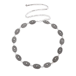 Close-up of vintage silver alloy waist chain with oval embossed metal plates and tassel