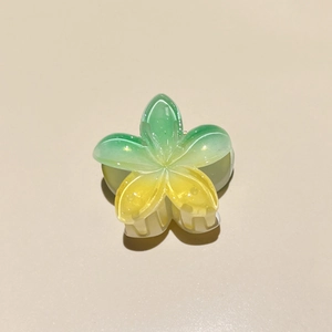 Macro detail of Frangipani hair claw clip with green and yellow gradient and glitter
