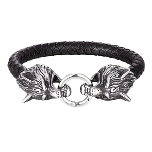 Detail of silver wolf head claps and braided black leather bracelet with viking style