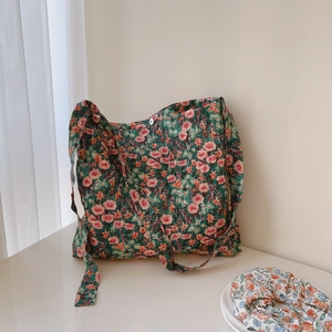 Detail of green floral quilted cotton tote bag with pink flowers and matching scrunchie