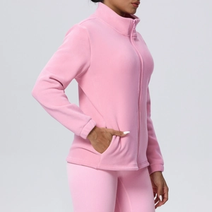 Detail of pink fleece jacket with high collar and full-zip closure on female model