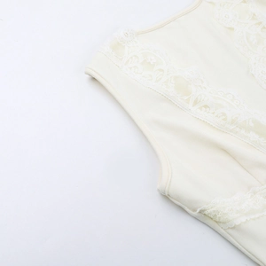 Close-up of elegant lace patchwork and V-neckline detail on a cream sleeveless top