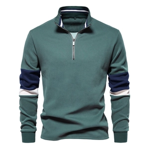Detail of teal long-sleeved polo sweatshirt with navy blue and white striped sleeves