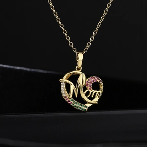 Gold heart Mom necklace with red, green, and clear zircon stones on a black background