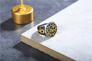Detail of Eye of Horus engraving and golden Ankh symbol on vintage stainless steel ring