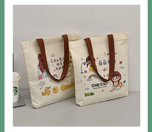Detailed close-up of cartoon canvas tote bags featuring inspirational quotes and handles