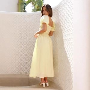 Elegant pale yellow puff sleeve midi dress with open back and high waist for summer vacations