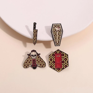 Dark punk metal enamel pins featuring moth, dagger, coffin, and hotel room 237 badge set