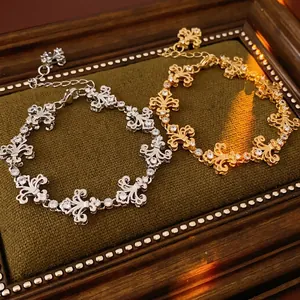 Vintage fleur-de-lis chain bracelets in gold and silver finish with zircon accents