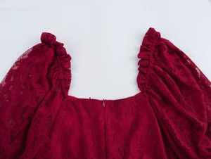 Détail de la robe en dentelle bordeaux montrant le col carré et les manches bouffantes