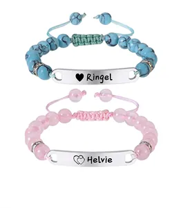 Close-up of customized stainless steel bracelets with pink and turquoise beads