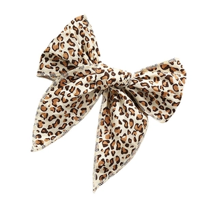Leopard print cotton bow hair clip for girls with elegant spotted pattern on white background