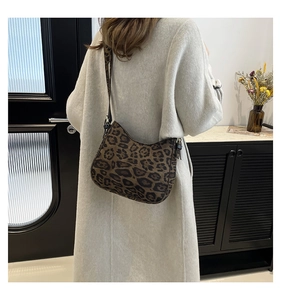 Detail view of large leopard print crossbody bag with adjustable wide shoulder strap