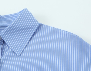 Detail of blue and white striped fabric texture on the casual button-down shirt collar