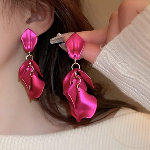 Close-up of rose red leaf petal drop earrings with long elegant tassel design