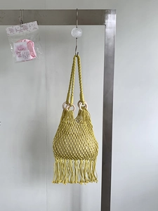 Handmade ginger yellow macrame tote bag with wooden handles and long fringe tassels