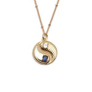 Gold plated Bagua pendant necklace featuring blue and white zircon stones on white background
