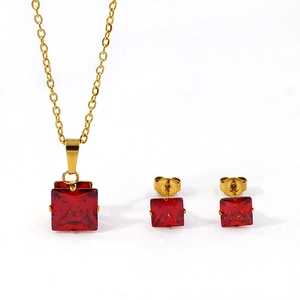 Macro shot of gold-plated square red zircon pendant and matching stud earrings set