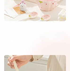 Detail of strawberry ceramic bowl with dual handles and matching spoon in pink pastel