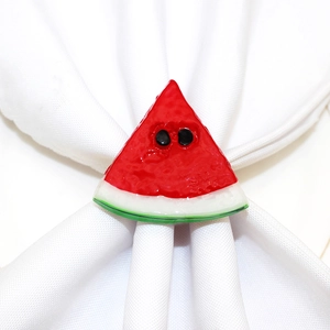 Watermelon slice napkin ring with red fruit and green rind on a white napkin