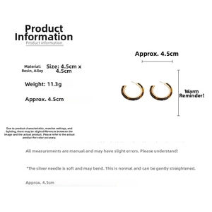 Detail showing retro resin hoop earrings with tortoiseshell texture and 4.5cm dimensions
