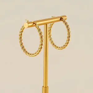 Chic 18K gold plated stainless steel twisted rope hoop earrings on a T-bar display stand