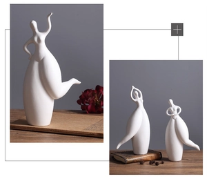 Detail of three white matte ceramic abstract figures showing smooth textures and elegant poses