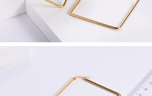 Macro shot of large square gold titanium steel hoop earrings with size measurement