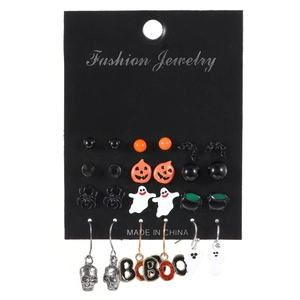 Halloween earring set with pumpkin, ghost, and skull charms on a black card