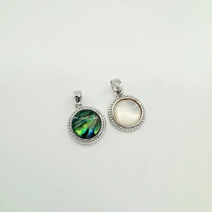 Macro detail of silver geometric shell pendants with zirconia inlay for jewelry making
