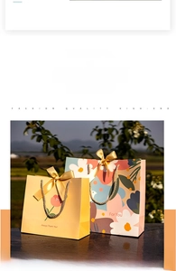 Floral gift bags with gold ribbon handles shown in garden setting with warm sunlight