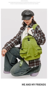 Fashionable green nylon space backpack shown on a model for hiking and daily commute