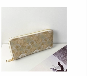 Detail view of damask long wallet with golden zipper and fan pattern on white background