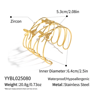 Detailed view of gold multi-layer dragonfly open cuff bangle with zirconia accents