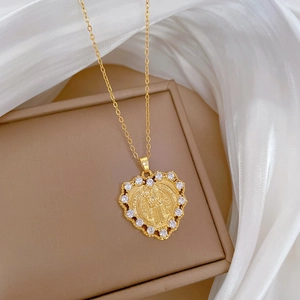 Luxury gold titanium heart necklace with crystal halo and religious saint medallion