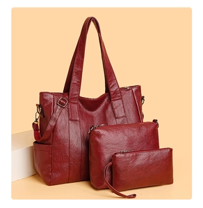 Close-up of a burgundy PU leather 3-piece set including a tote, crossbody bag, and pouch