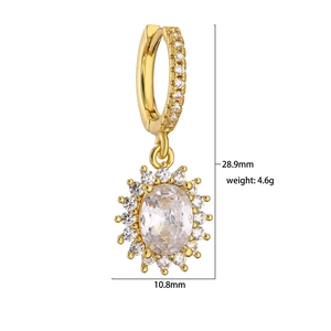 Detailed view of gold-plated huggie earring with oval zircon and halo crystals