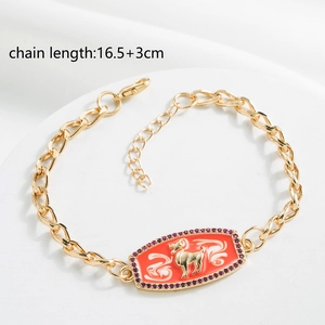 Detail of 18K gold plated chain bracelet with red Aries enamel pendant and purple stones