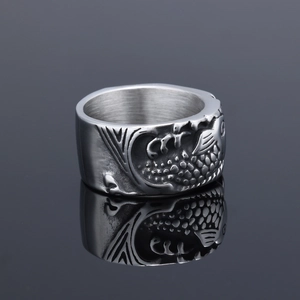 Silver stainless steel ring with 3D fish scale pattern on dark reflective surface