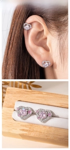Detail showing pink heart screw back stud earrings on ear and in jewelry box