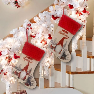 Hanging Christmas stockings with gnomes and reindeer patterns on festive stairs
