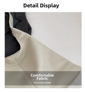 Close-up of cream white tote bag showing soft lychee grain texture and premium stitching
