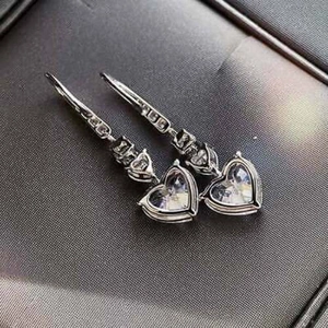 Sparkling S925 silver heart dangle earrings with clear crystals in a jewelry box