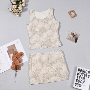 Close-up of 3D floral sequins and hollow-out texture on ivory two-piece skirt set