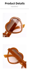 Close-up of heart-shaped sunglasses with amber glitter frames and gradient lenses