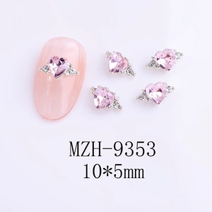 Detailed macro view of 10x5mm pink heart-shaped nail charm with side crystals