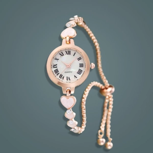 Detail of rose gold heart bracelet watch with crystal accents and quartz dial